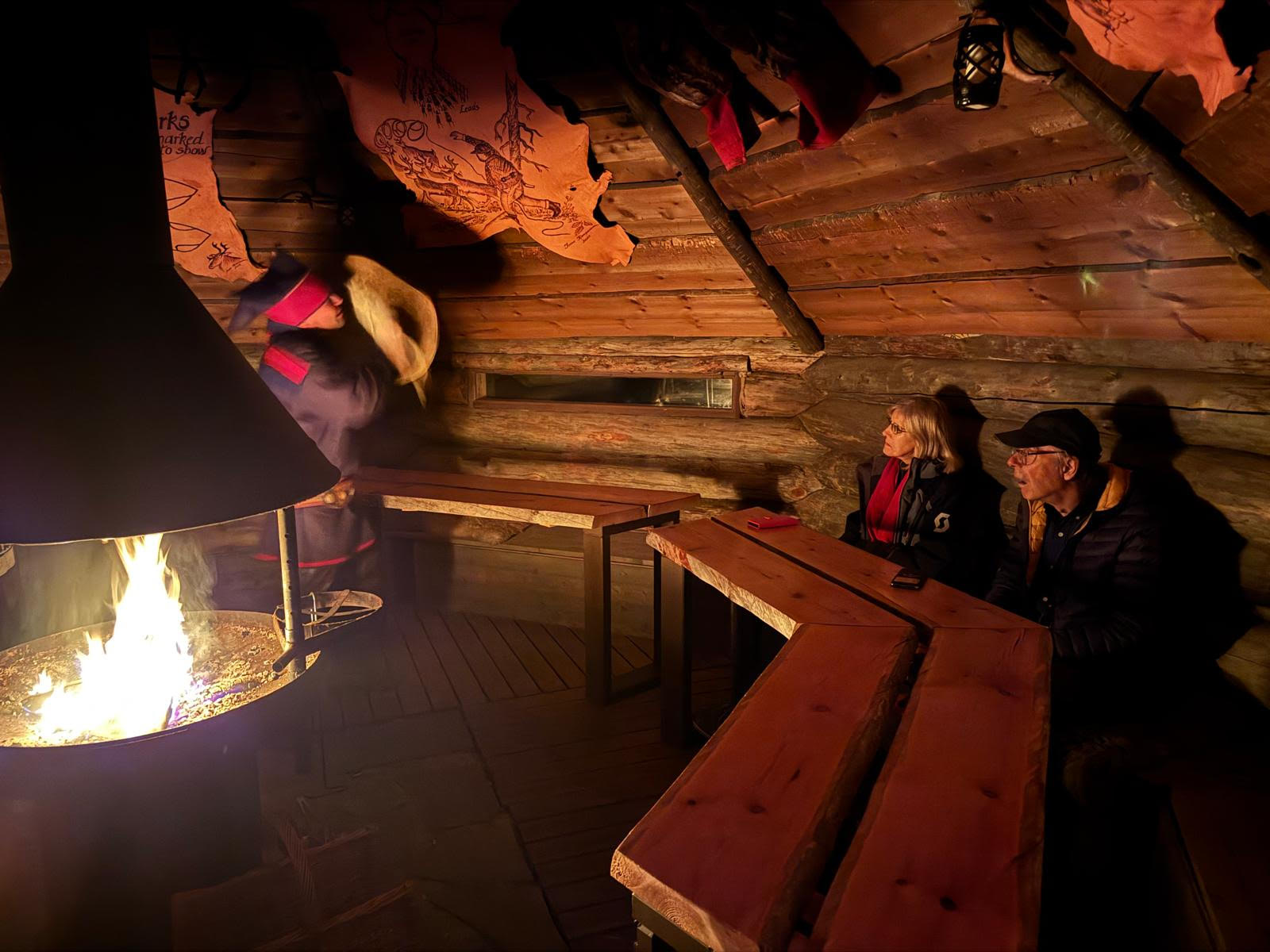 A Sami artist entertains Karen and Derek to a Joik performance in Lapland Hut, Karen's source